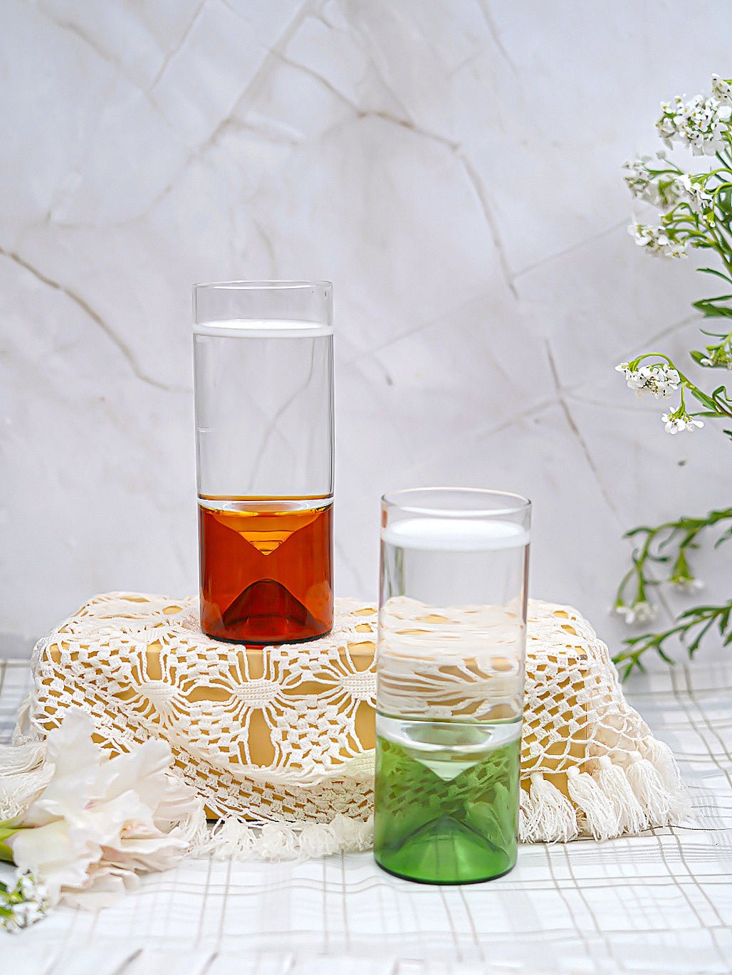 Detailed view of borosilicate highball glass with a geometric green base, highlighting its unique craftsmanship.